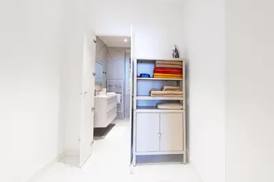 a room with a closet with white cabinets and a sink at Bord de mer - Beau 2 pièces rénové - Parking - EX in Èze