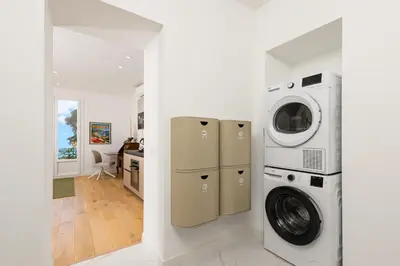 a white laundry room with a washer and dryer at Bord de mer - Beau 2 pièces rénové - Parking - EX in Èze