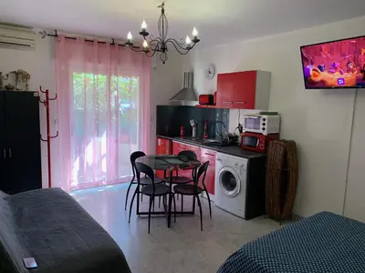 a kitchen with a table and chairs and a microwave at Studio NICE near the sea in Nice