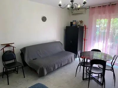 a bedroom with a bed and a table and chairs at Studio NICE near the sea in Nice