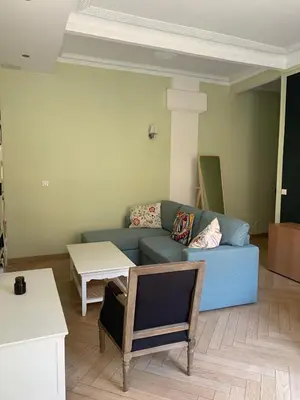 a living room with a blue couch and a table at Appartement et terrasse Nice centre in Nice