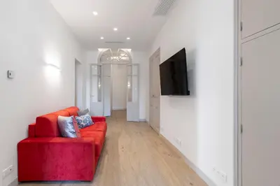 a living room with a red couch and a flat screen tv at 