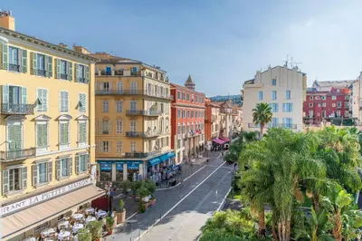 a city street with many buildings and palm trees at 