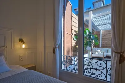 a bedroom with a balcony with a bed and a window at Nice Charm XXL Terrace in Nice