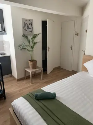 a bedroom with a bed and a potted plant at Bottero nice in Nice