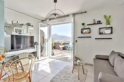 a living room with a couch and a table at Heidi Braesch Apartment in Nice