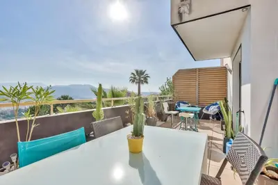 a balcony with a white table and chairs at Heidi Braesch Apartment in Nice
