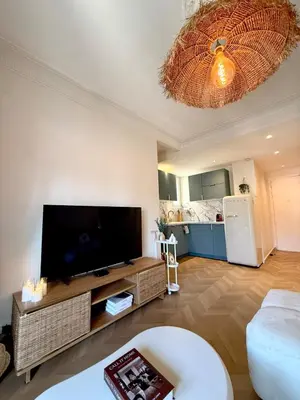 a living room with a large flat screen tv at Beachfront Appartment Nice Promenade des anglais 2 terraces in Nice