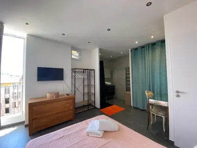 a bedroom with a bed and a dresser and a television at Beautiful 2 rooms 45 m2 Nice in Nice