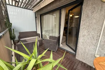 a balcony with chairs and a table and a plant at Cozy apartment in the heart of Nice in Nice