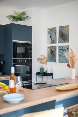 a kitchen with a counter with a stove top oven at Modern Luxury - Sea View over Èze Village in Èze