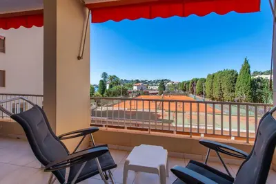 a room with chairs and a balcony with a view at fisher in Beaulieu-sur-Mer
