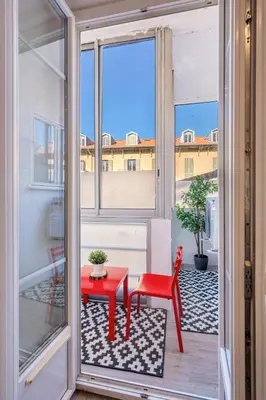 a balcony with a red table and a red bench at Chambre 4 La Nissa Bella in Nice