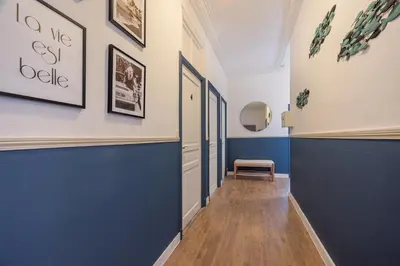 a hallway with blue and white walls and a bench at Chambre 4 La Nissa Bella in Nice