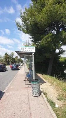 a bus stop with a person sitting under it at Cagnes 4 Pers Parking Bord de Mer Terrasse Clim in Cagnes-sur-Mer