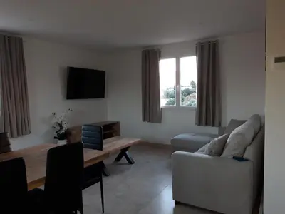 a living room with a couch and a table at Gite Maïoun Cremat in Nice