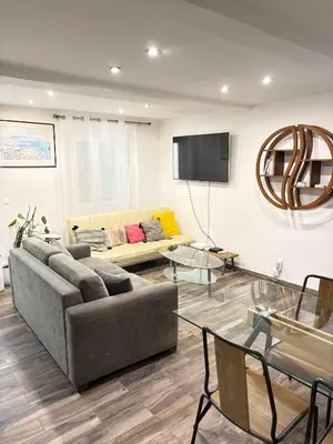 a living room with a couch and a table at T2 cosy et climatise Vieux Nice Garibaldi in Nice