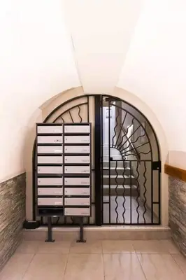 a black gate in a room with a wall at T2 cosy et climatise Vieux Nice Garibaldi in Nice