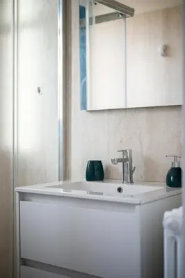 a bathroom with a white sink and a mirror at Casa Nissa Vieux-Nice in Nice