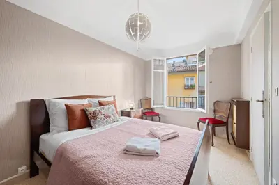a bedroom with a large bed and a window at Casa Nissa Vieux-Nice in Nice