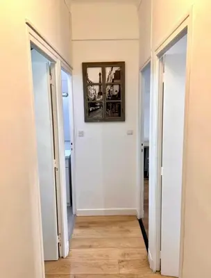 a hallway with two doors and a mirror on the wall at Beaumont Résidence in Nice