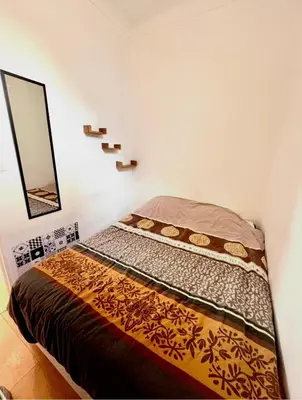 a bed in a room with a mirror at Beaumont Résidence in Nice