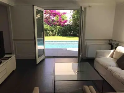 a living room with a couch and a glass table at Luxury villa with Pool and Garden perfect location in Beaulieu-sur-Mer