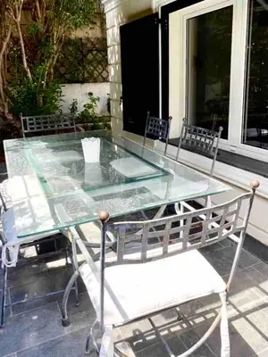 a glass table and chairs on a patio at Luxury villa with Pool and Garden perfect location in Beaulieu-sur-Mer