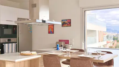 a kitchen with a table with chairs and a large window at La Vista Mar - Apt Seaview Near Airport-AC-Parking in Saint-Laurent-du-Var