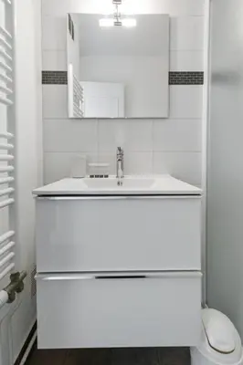 a white bathroom with a sink and a toilet at Le Galion - City centre - Bright - AC - Parking in Cagnes-sur-Mer