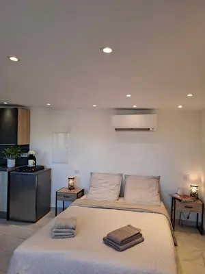 a bedroom with a bed with two towels on it at Studio de la Villa Thérèse, Piscine & Jardin in Saint-Laurent-du-Var