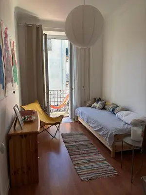 a bedroom with a bed and a door to a balcony at 3 pièces lumineuses, 3 nuitées minimum in Nice