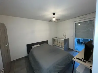 a bedroom with a bed and a desk and a television at Le Riviera in Nice