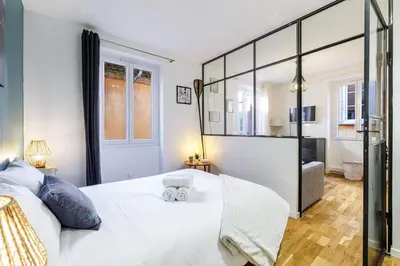 a bedroom with a large white bed and a mirror at 1 GALLO LOT 3 - Joli appartement au coeur du Vieux-Nice - AC in Nice