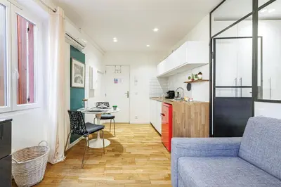 a kitchen and living room with a couch and a table at 1 GALLO LOT 3 - Joli appartement au coeur du Vieux-Nice - AC in Nice