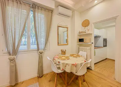 a kitchen and dining room with a table and chairs at Cherie in Nice in Nice