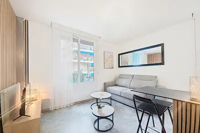a living room with a couch and a table and chairs at Beach Studio on Cagnes sea front in Cagnes-sur-Mer