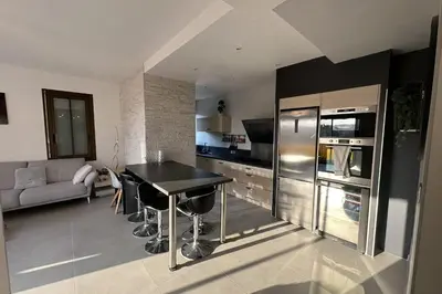 a kitchen with a black table and a refrigerator at Spacious apartment in Nice with balcony in Nice