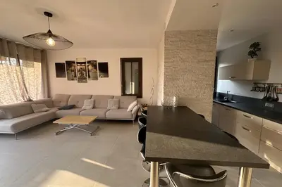 a kitchen and living room with a couch and a table at Spacious apartment in Nice with balcony in Nice