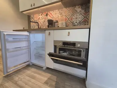 a kitchen with an open refrigerator and an oven at petit appart cozy in Nice