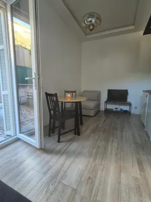 a living room with a table and a couch at petit appart cozy in Nice