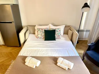 a bed in a room with two pillows on it at Chic et élégant - au cœur du Carré d'Or in Nice