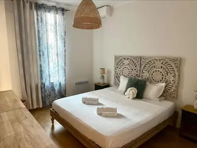 a bedroom with a large bed with two trays on it at Chic et élégant - au cœur du Carré d'Or in Nice