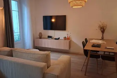 a living room with a couch and a table at Charming bright apartment in Nice in Nice