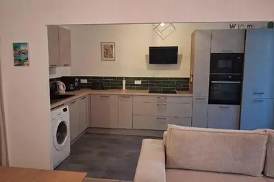 a kitchen with a couch and a washer and dryer at Charming bright apartment in Nice in Nice