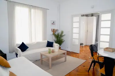 a living room with a white couch and a table at Fantastic Centra Peaceful Location in Nice