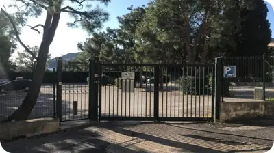 a black metal gate with a parking lot at Mer et Soleil in Villefranche-sur-Mer