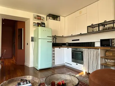 a kitchen with a green refrigerator in a room at L'âme de Nice - Terrasse dorée sur Place Masséna in Nice