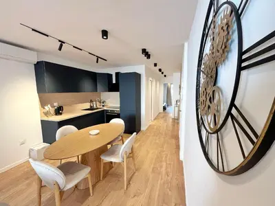 a kitchen and dining room with a wooden table and chairs at Ref 127 - 3 Pièces 2 chambres Nice Port in Nice