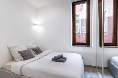 a white bed in a room with a window at Authentic Nice Old Town, separate bedroom, AC in Nice